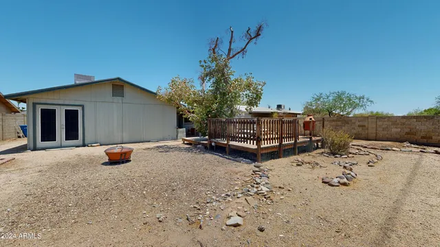 a view of a backyard with sitting area