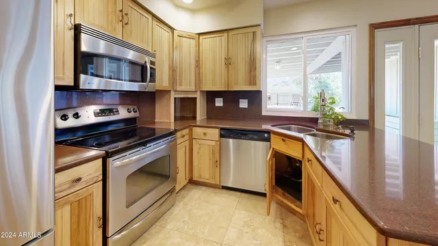 a kitchen with a stove a sink and a microwave