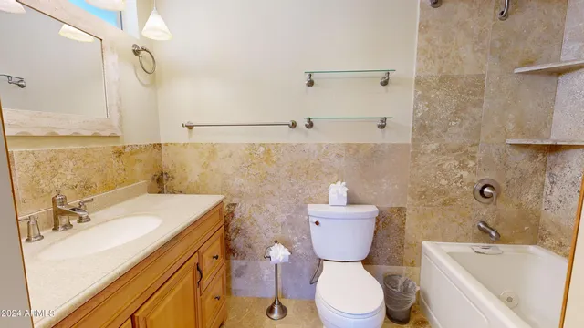 a bathroom with a sink toilet vanity and bathtub