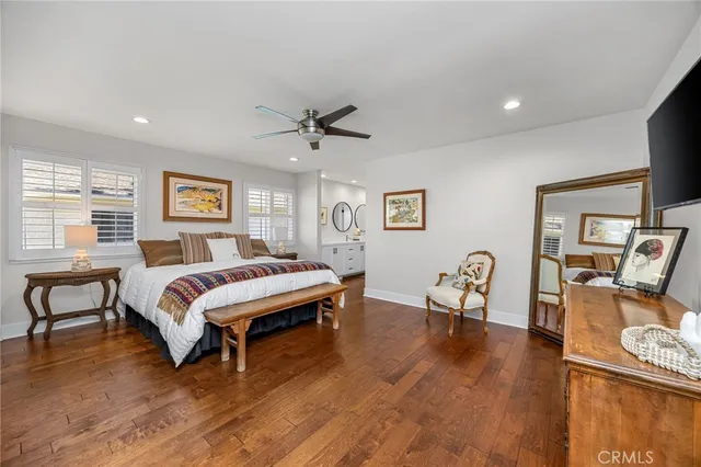 a spacious bedroom with a bed a table and chair