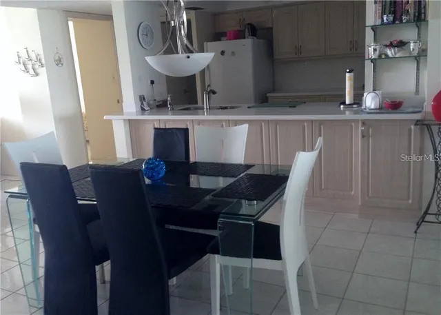 a kitchen with a table chairs and a refrigerator