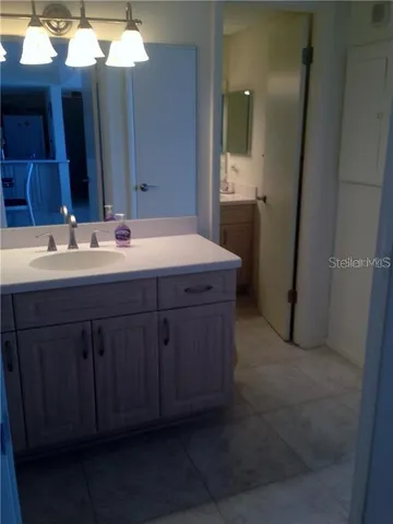 a bathroom with a double vanity sink and mirror