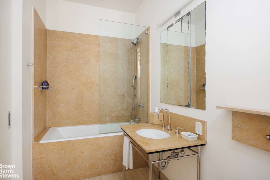 129 Greene Street, Unit 2 Manhattan, NY 10012 - Photo 10 of 12 a bathroom with a sink and a mirror