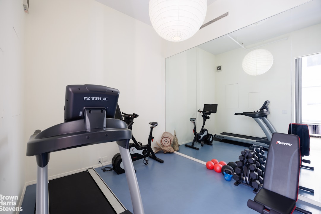 129 Greene Street, Unit 2 Manhattan, NY 10012 - Photo 11 of 12 a view of a room with gym equipment