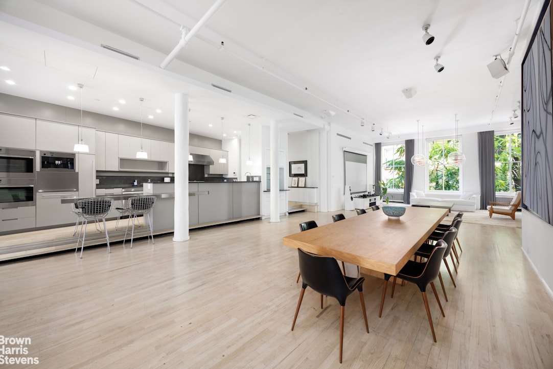 129 Greene Street, Unit 2 Manhattan, NY 10012 - Photo 2 of 12 a large kitchen with a table and chairs