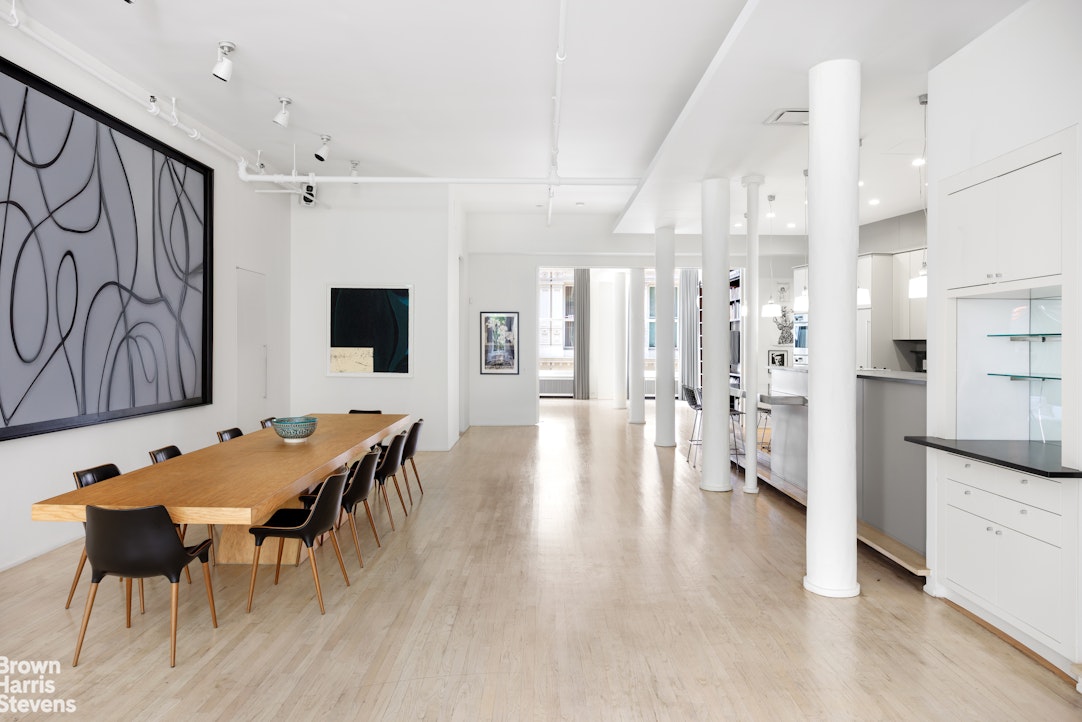 129 Greene Street, Unit 2 Manhattan, NY 10012 - Photo 3 of 12 a view of a dining room with furniture and wooden floor