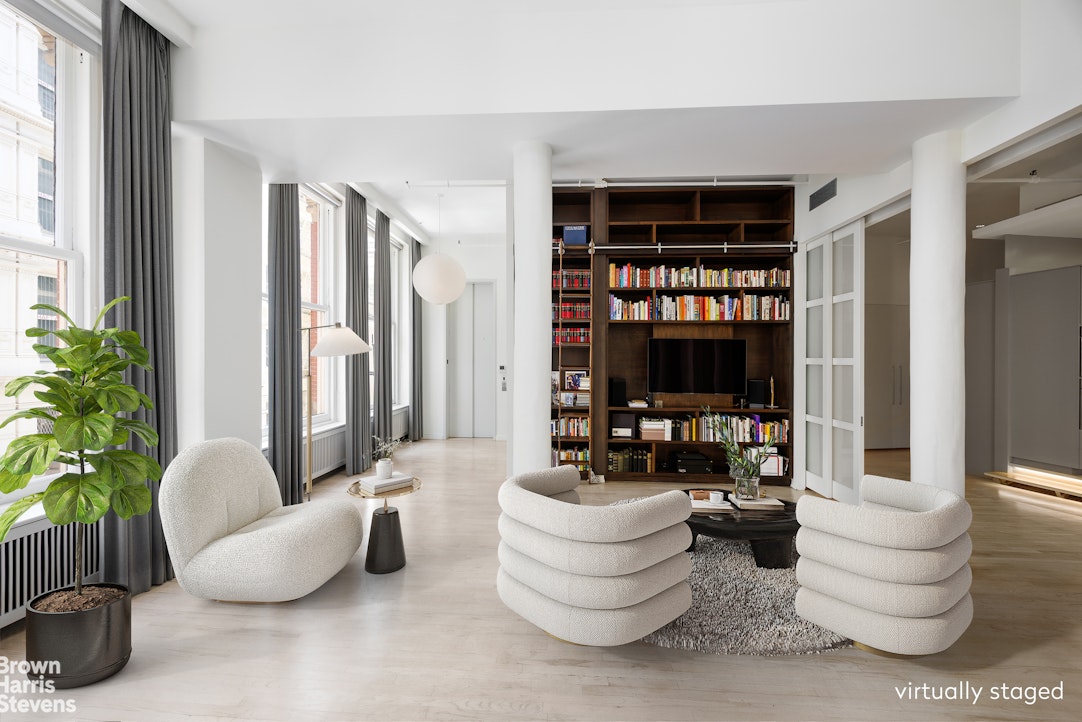 129 Greene Street, Unit 2 Manhattan, NY 10012 - Photo 8 of 12 a living room with furniture and a potted plant