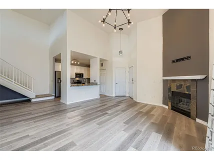 a view of empty room with wooden floor and fireplace