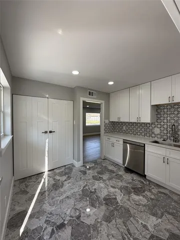 a large kitchen with lot of cabinets and appliances