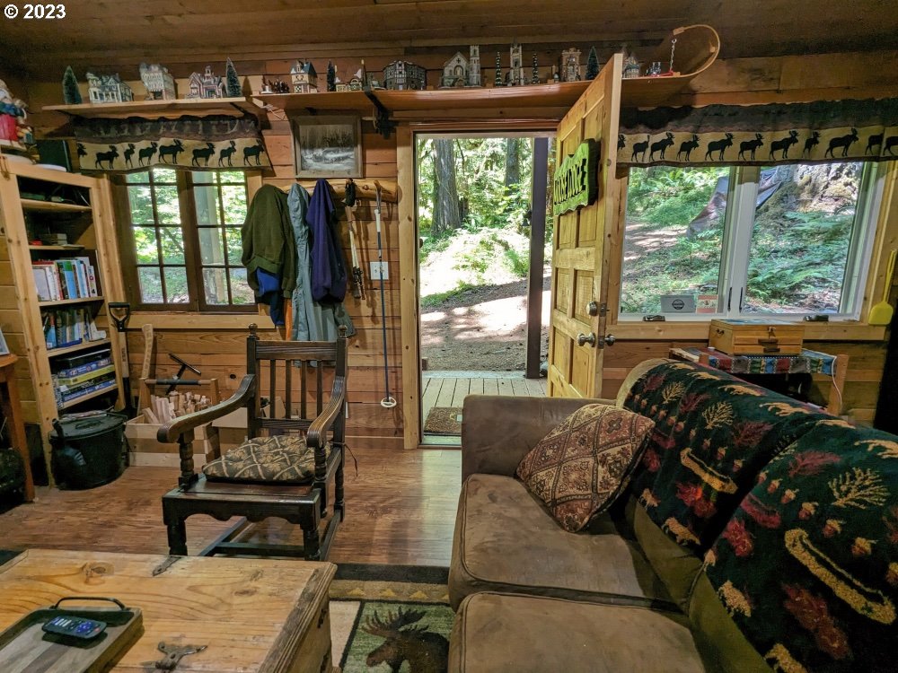 27558 Still Creek Road Rhododendron, OR 97049 - Photo 8 of 37 a living room with furniture and large windows