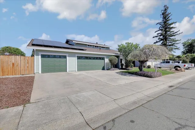a front view of a house with a garden
