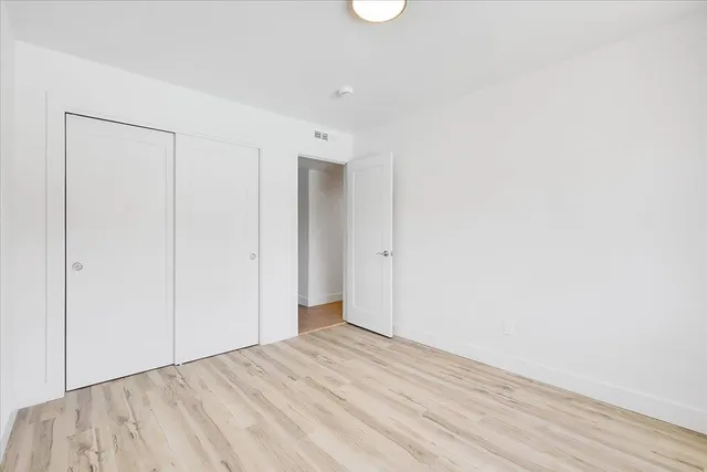 a kitchen with stainless steel appliances granite countertop a sink a stove and cabinets