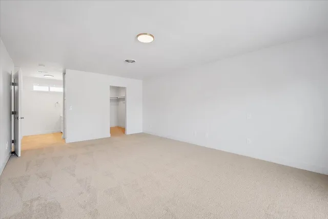 a view of a house with backyard and wooden fence