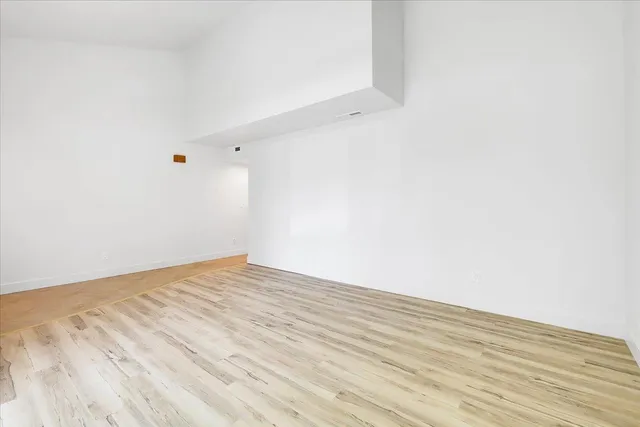 a kitchen with stainless steel appliances a sink a counter top space cabinets and a window