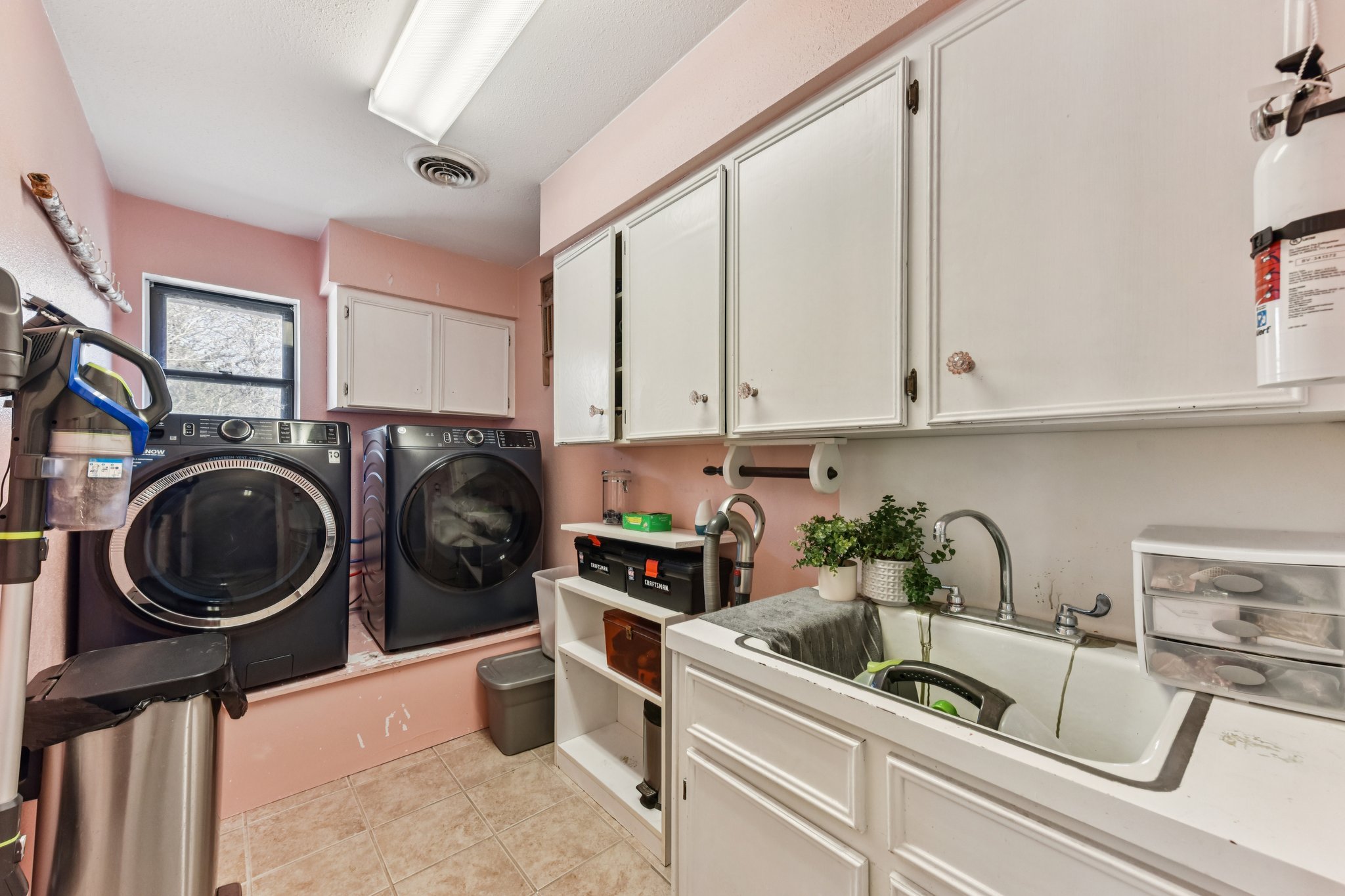 111 Post Oak Lane Elgin, TX 78621 - Photo 19 of 39 a view of a storage and utility room with sink washer and dryer