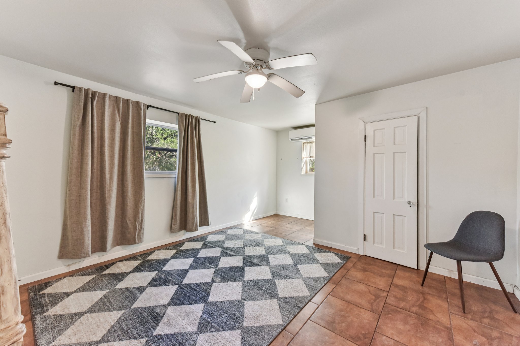 111 Post Oak Lane Elgin, TX 78621 - Photo 31 of 39 a view of a bedroom with wooden floor and a ceiling fan