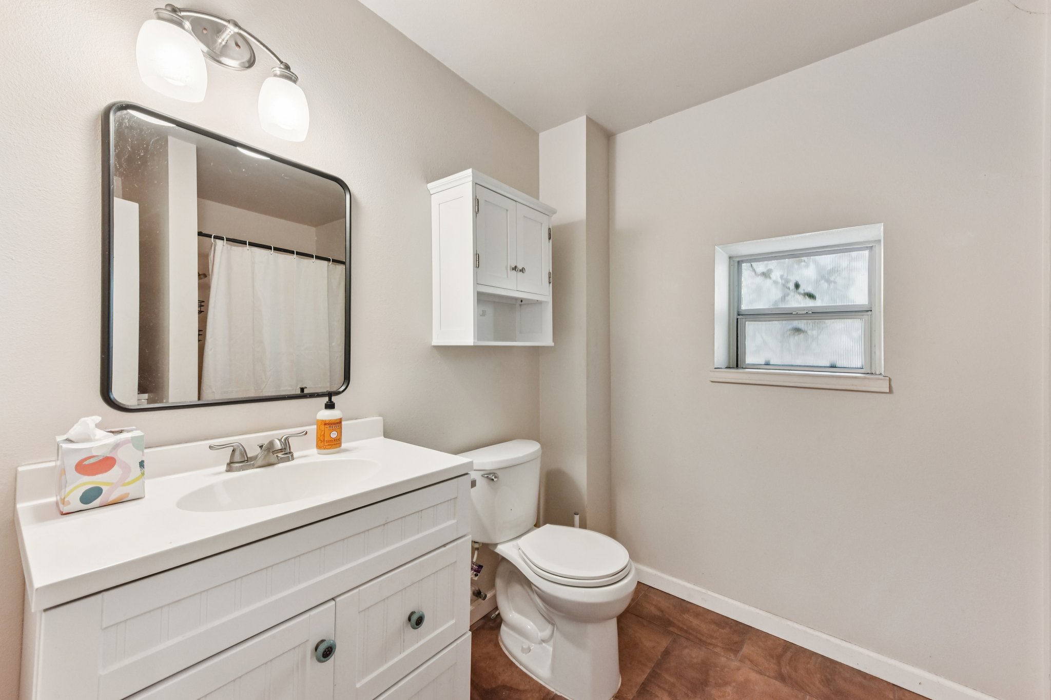 111 Post Oak Lane Elgin, TX 78621 - Photo 32 of 39 a bathroom with a toilet sink and mirror