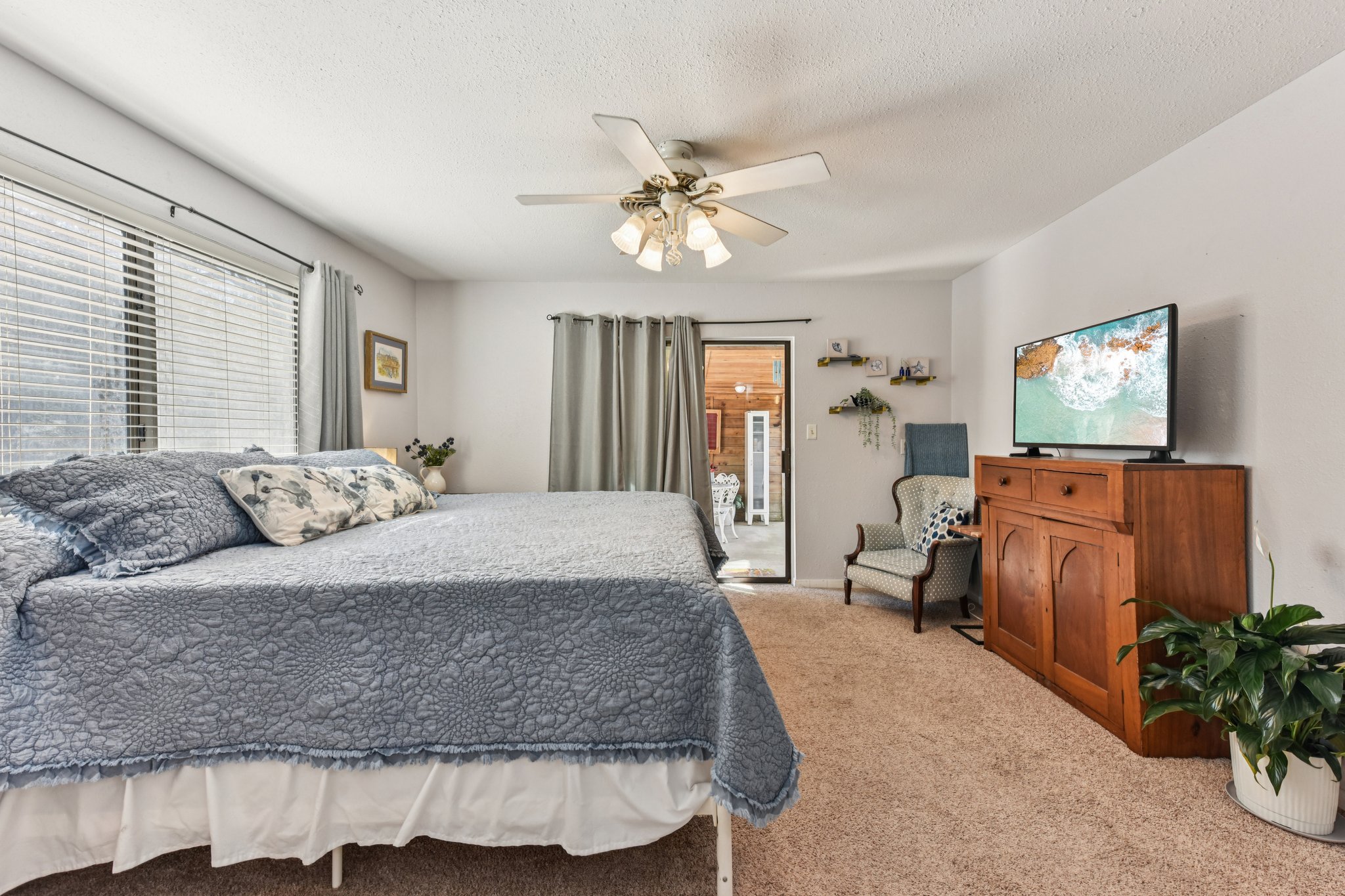 111 Post Oak Lane Elgin, TX 78621 - Photo 9 of 39 a spacious bedroom with a bed and a chandelier