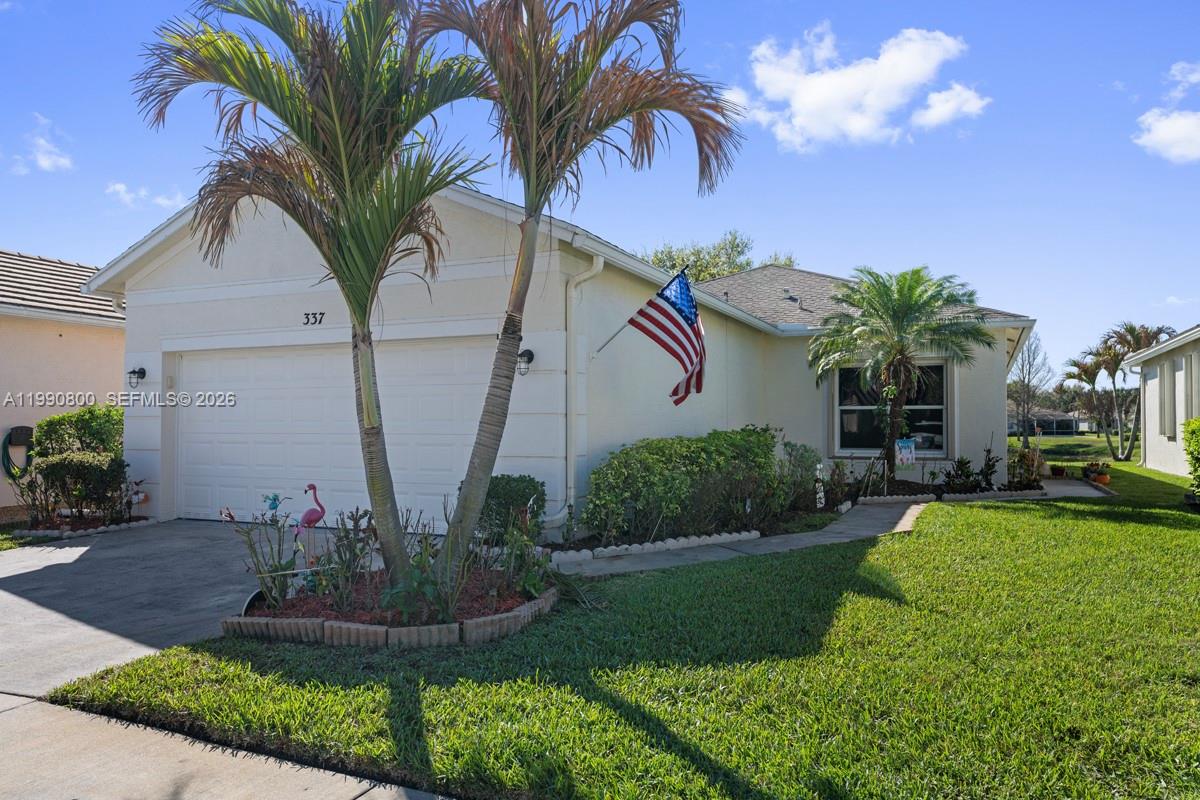 337 Southwest Maclay Way Port St. Lucie, FL 34986 - Photo 3 of 44 a view of a house with a yard and potted plants