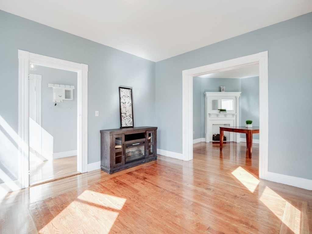 38 Cherry Street, Unit 2 Lynn, MA 01902 - Photo 14 of 40 a living room with furniture and a dining table with wooden floor