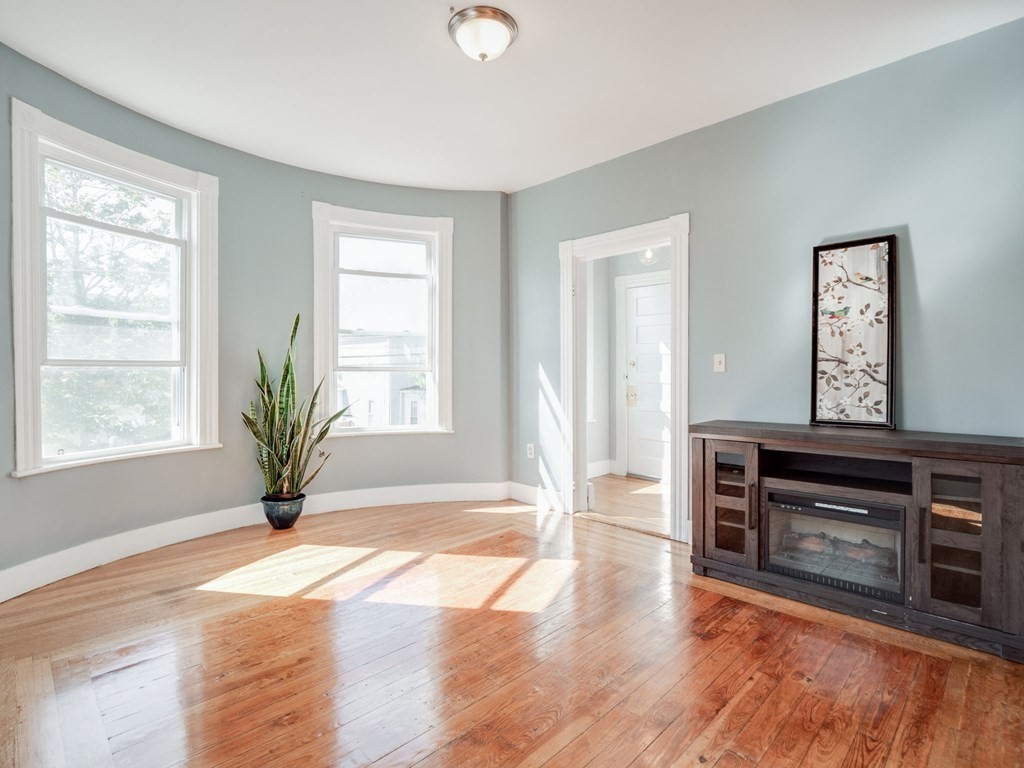 38 Cherry Street, Unit 2 Lynn, MA 01902 - Photo 15 of 40 a view of empty room with wooden floor and fan