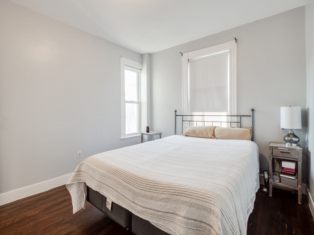 38 Cherry Street, Unit 2 Lynn, MA 01902 - Photo 19 of 40 a bedroom with a bed and wooden floor