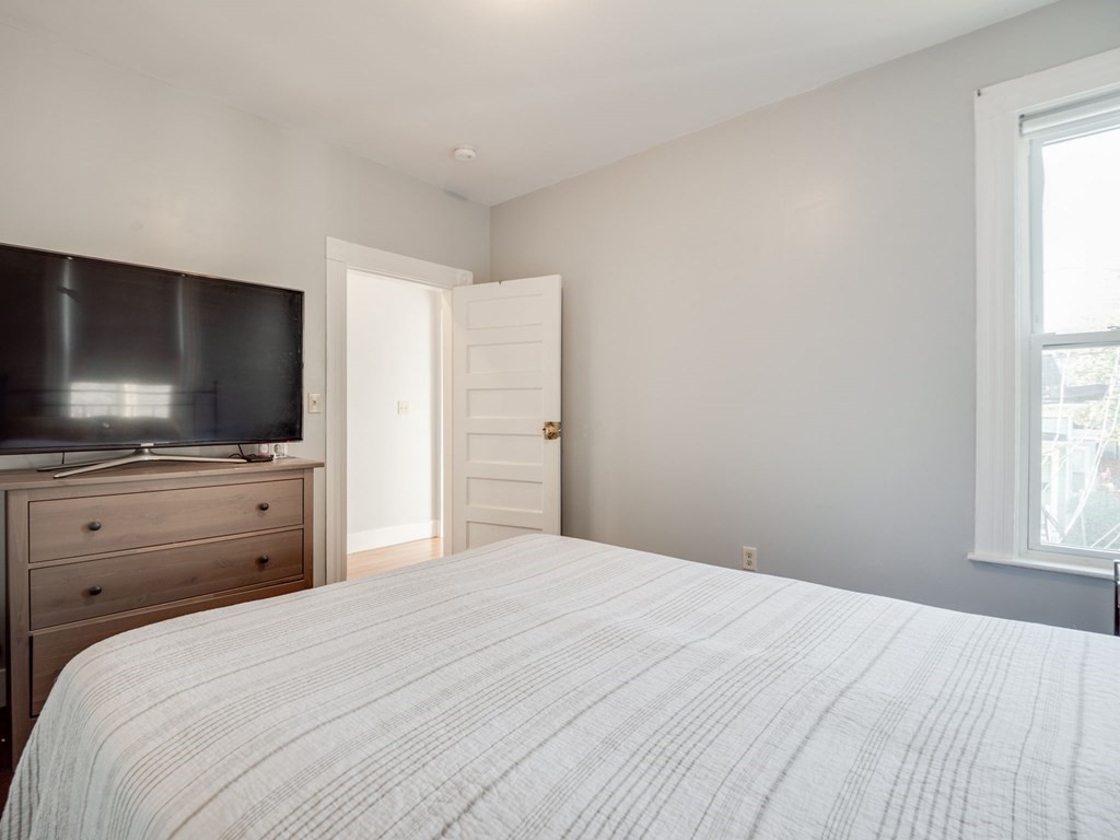 38 Cherry Street, Unit 2 Lynn, MA 01902 - Photo 20 of 40 a bedroom with a bed and a flat screen tv