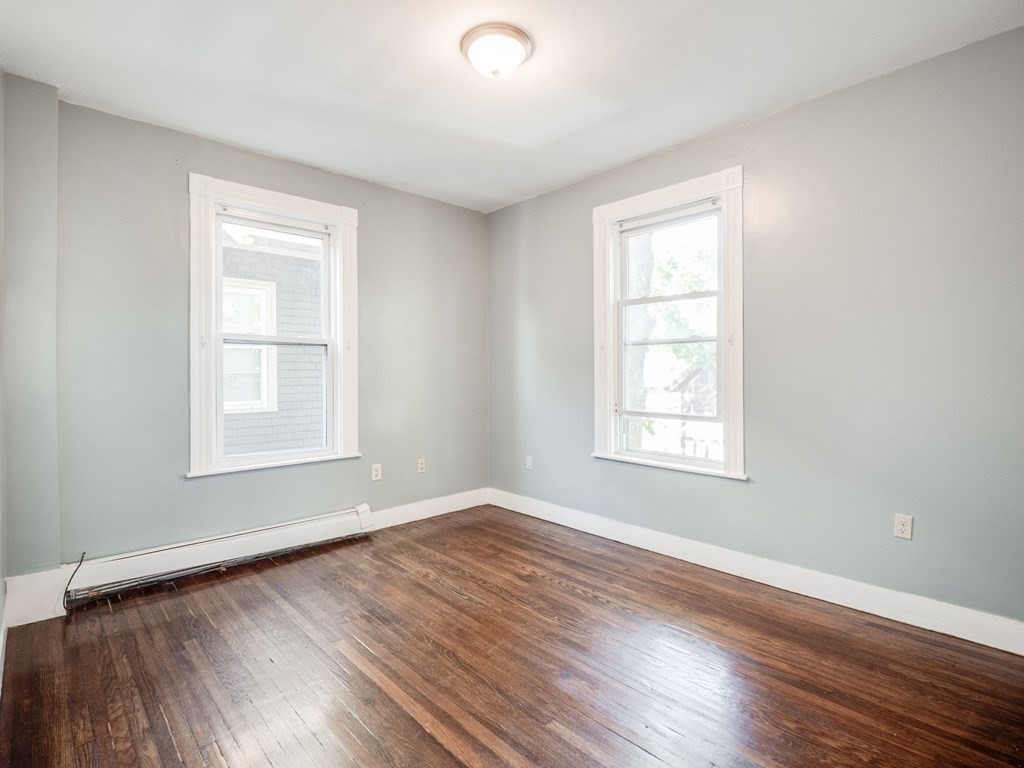 38 Cherry Street, Unit 2 Lynn, MA 01902 - Photo 26 of 40 a view of an empty room with wooden floor and a window