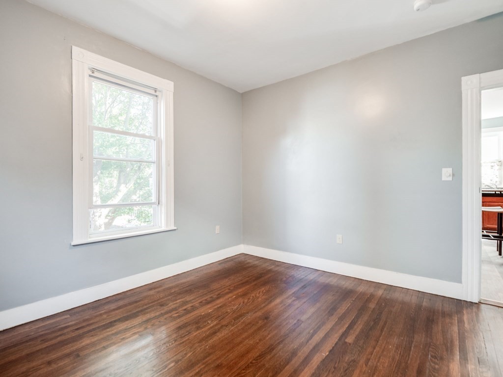 38 Cherry Street, Unit 2 Lynn, MA 01902 - Photo 29 of 40 a view of an empty room with wooden floor and a window