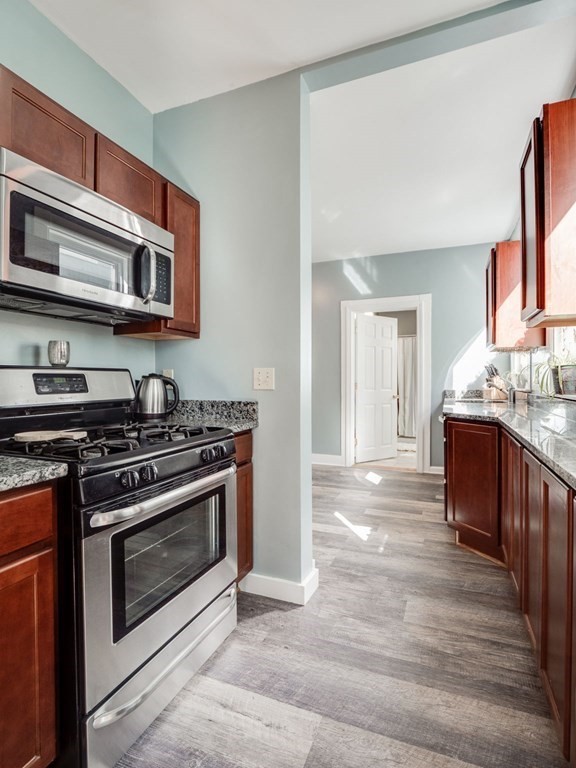 38 Cherry Street, Unit 2 Lynn, MA 01902 - Photo 3 of 40 a kitchen with stainless steel appliances granite countertop a stove and a sink