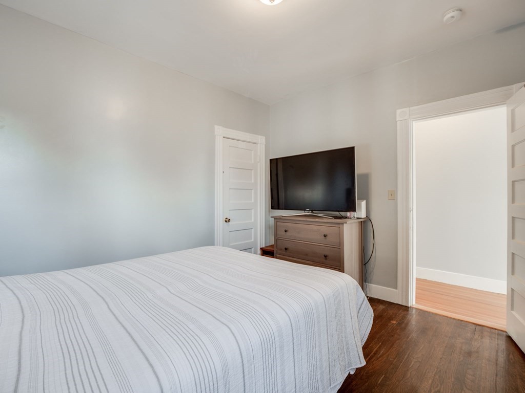 38 Cherry Street, Unit 2 Lynn, MA 01902 - Photo 31 of 40 a bedroom with a bed and a flat screen tv
