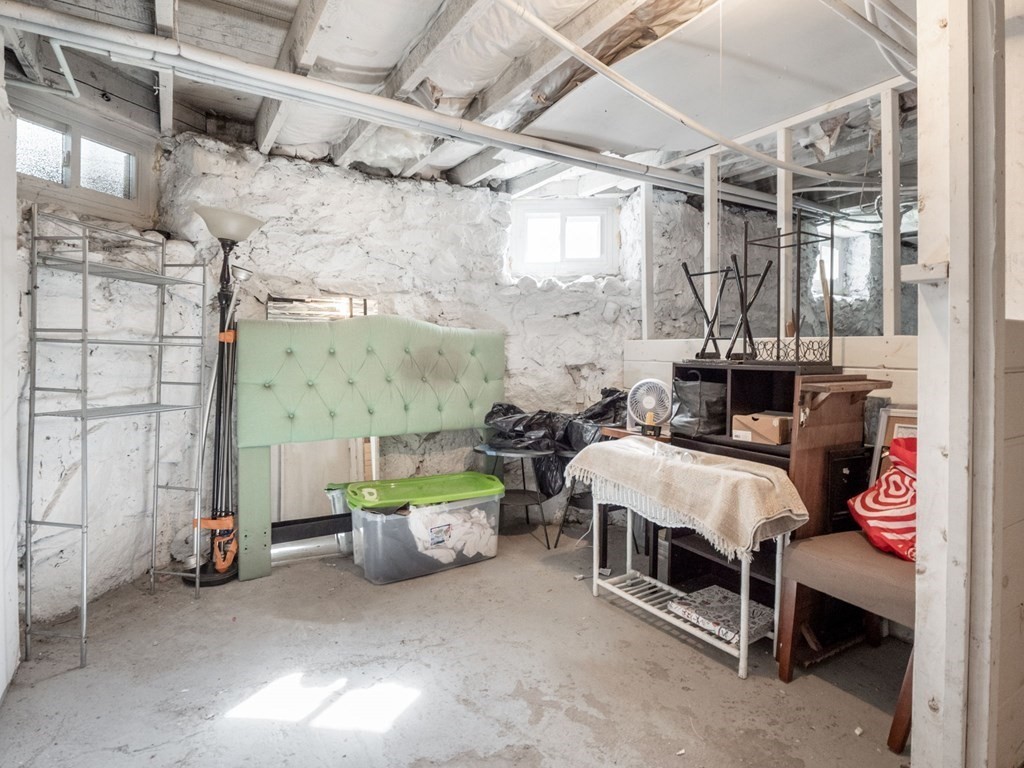 38 Cherry Street, Unit 2 Lynn, MA 01902 - Photo 35 of 40 a bed room with a bed and a chair
