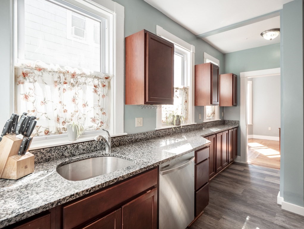 38 Cherry Street, Unit 2 Lynn, MA 01902 - Photo 4 of 40 a kitchen with granite countertop a sink and a window