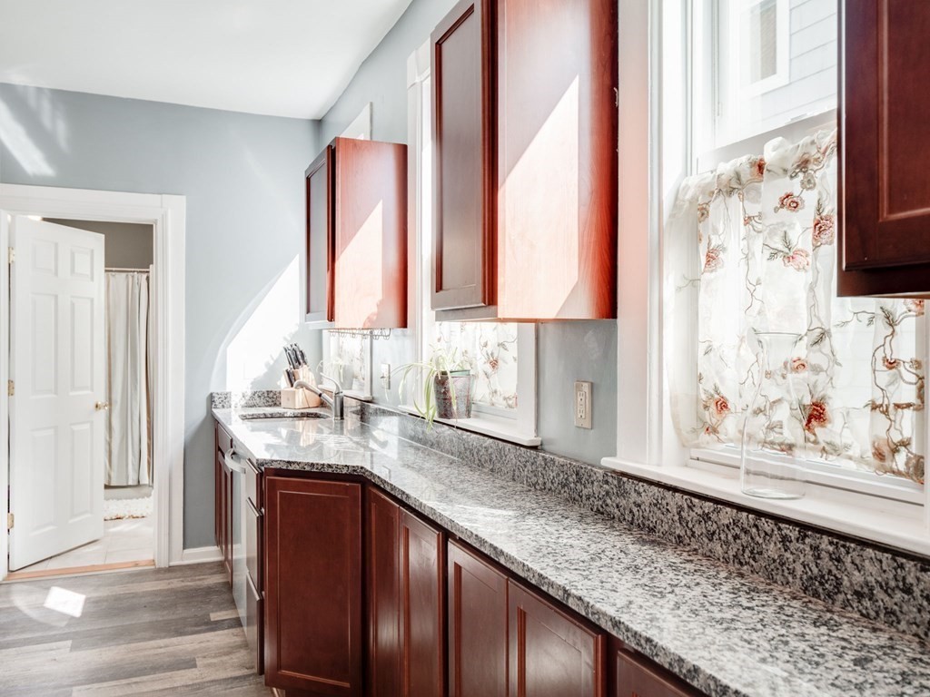 38 Cherry Street, Unit 2 Lynn, MA 01902 - Photo 5 of 40 a kitchen with stainless steel appliances granite countertop a sink and a window