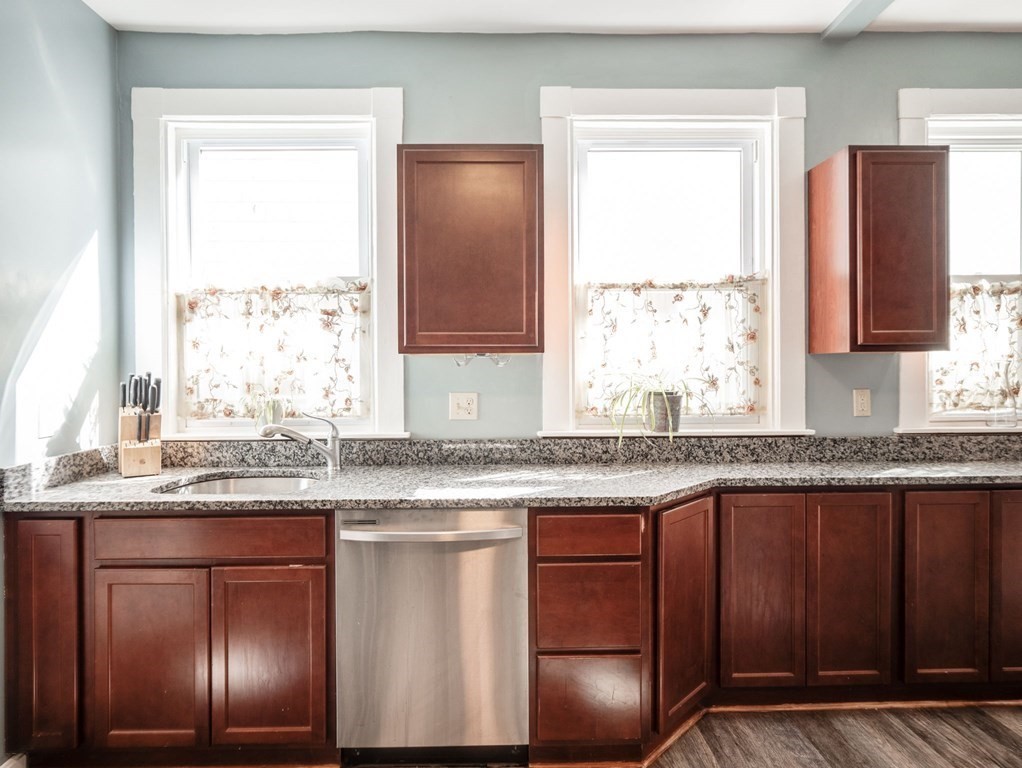 38 Cherry Street, Unit 2 Lynn, MA 01902 - Photo 8 of 40 a kitchen with granite countertop stainless steel appliances a sink window and cabinets