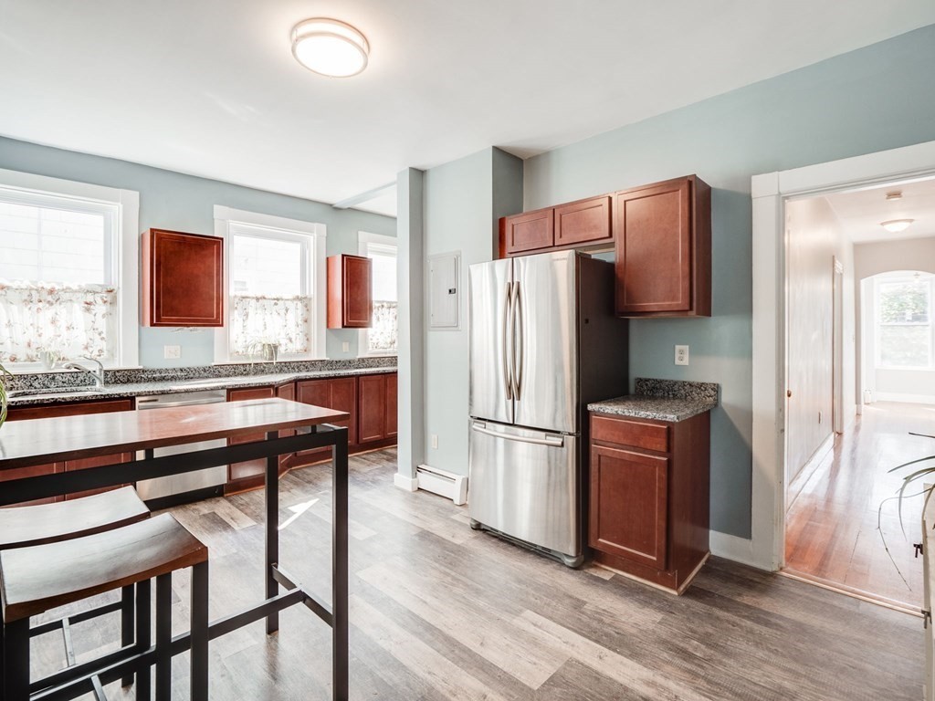 38 Cherry Street, Unit 2 Lynn, MA 01902 - Photo 10 of 40 a kitchen with stainless steel appliances a refrigerator a stove a sink and a dining table