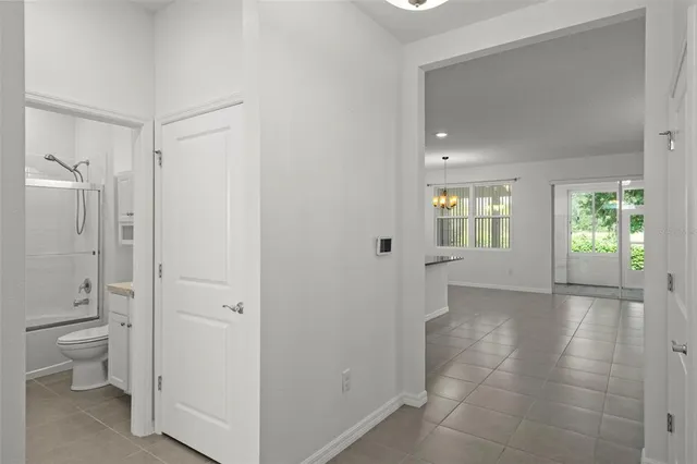 a bathroom with a granite countertop toilet sink and mirror