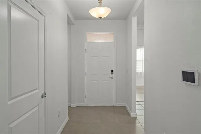 an empty room with windows and entrance