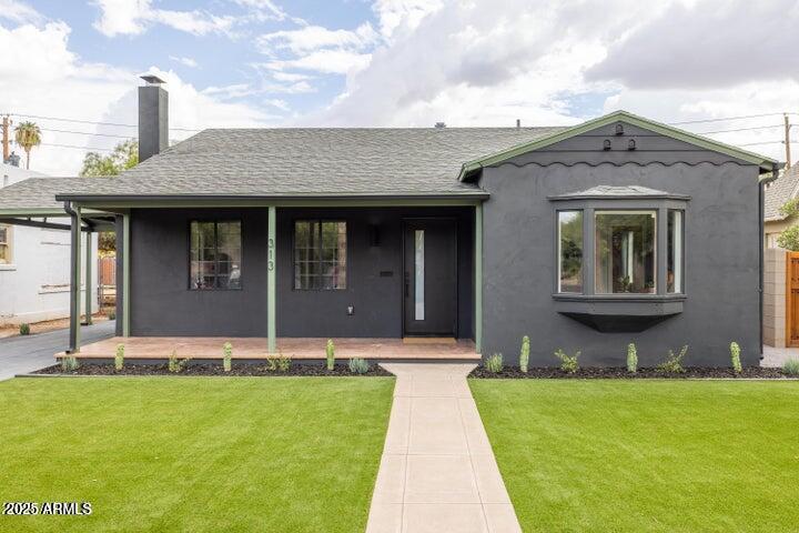 a front view of a house with garden