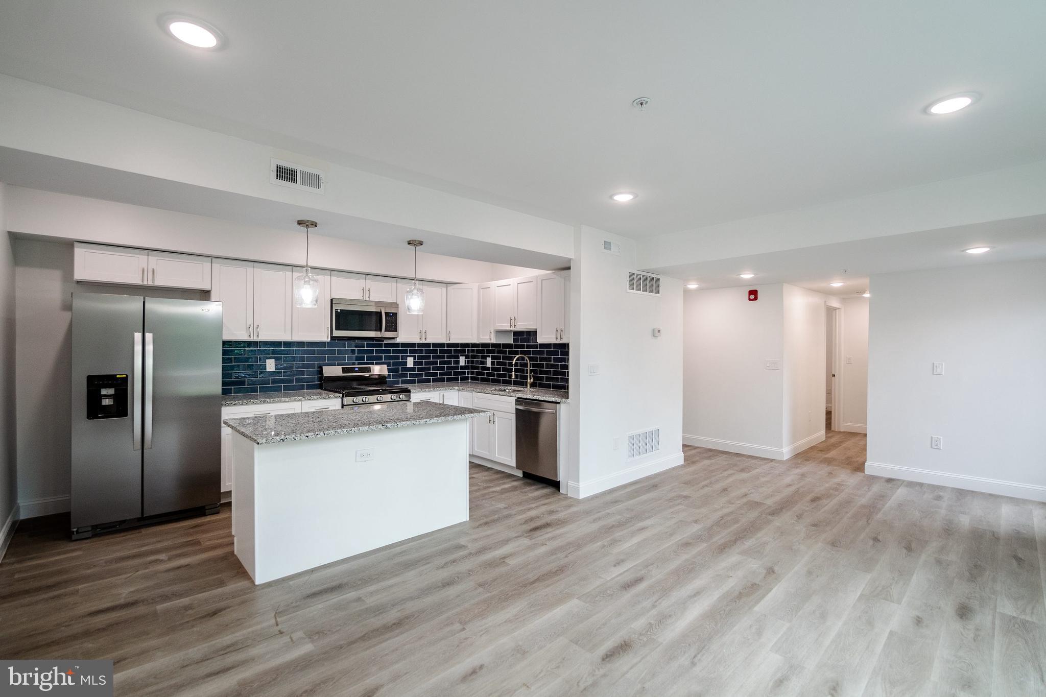 129 Washington Avenue, Unit B Philadelphia, PA 19147 - Photo 1 of 18 a kitchen with stainless steel appliances granite countertop a refrigerator and a stove top oven