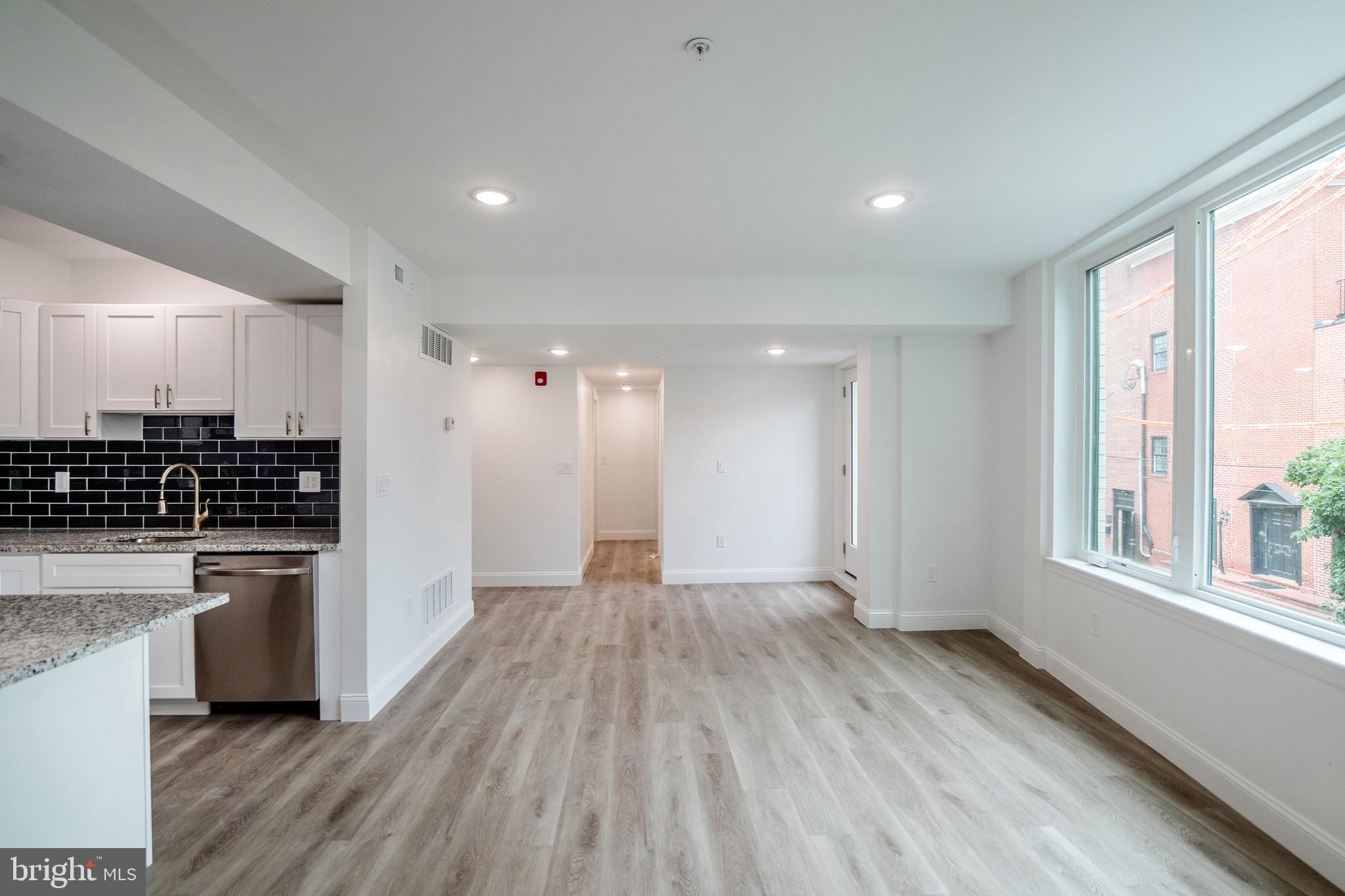 129 Washington Avenue, Unit B Philadelphia, PA 19147 - Photo 2 of 18 a view of kitchen with wooden floor and electronic appliances