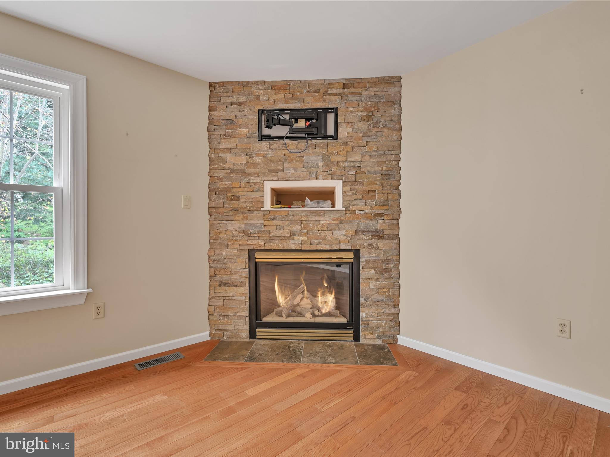 2602 Andrew Drive Sinking Spring, PA 19608 - Photo 19 of 47 a view of an empty room with wooden floor and a fireplace