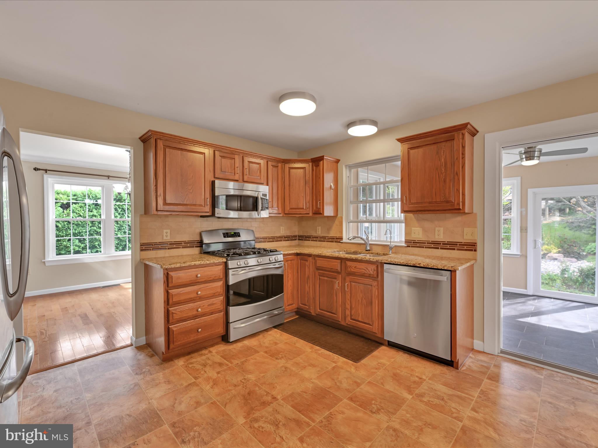 2602 Andrew Drive Sinking Spring, PA 19608 - Photo 20 of 47 a kitchen with granite countertop a stove top oven sink and cabinets