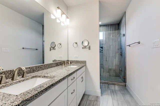 a bathroom with a granite countertop sink mirror and double