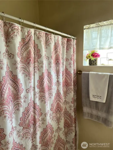 a view of walk in closet with clothes