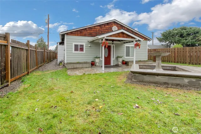 a front view of a house with a yard table and chairs