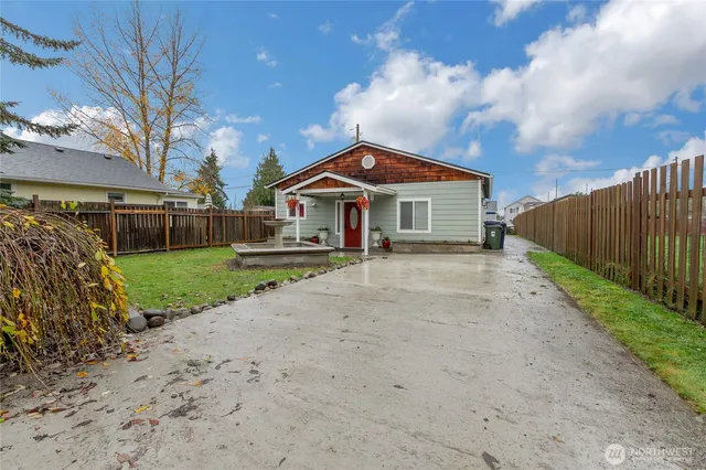 a front view of a house with a yard and fence
