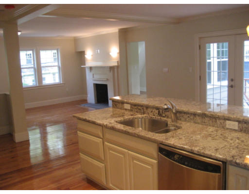 54 Beaconsfield Road, Unit 1 Brookline, MA 02445 - Photo 2 of 7 a kitchen with granite countertop stainless steel appliances sink and wooden floor