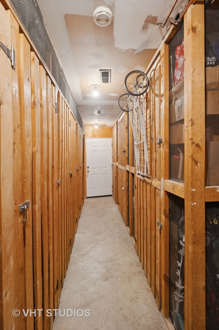 7200 North Ridge Boulevard, Unit 2C Chicago, IL 60645 - Photo 19 of 20 a view of a hallway with wooden floor and staircase