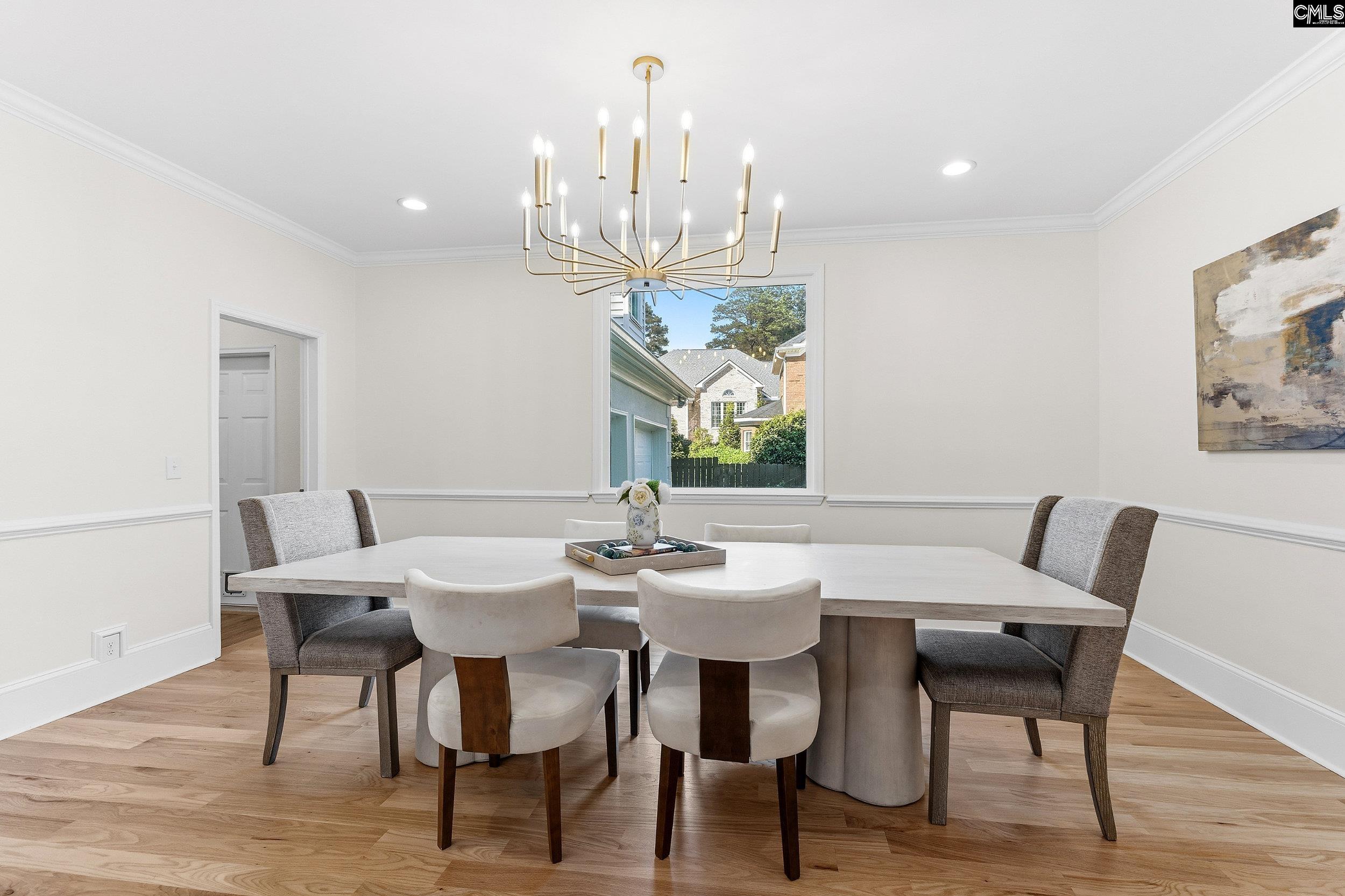 121 Silver Lake Road East Columbia, SC 29223 - Photo 17 of 57 a view of a dining room with furniture a chandelier and wooden floor